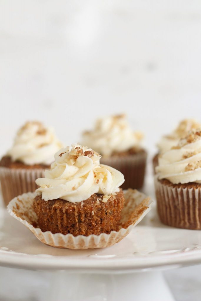This carrot cake cupcakes recipe is the best, most easy recipe from scratch and will be your next go-to recipe every time you need to make a dessert for a loved one. The minced carrots make them incredible moist, and the homemade buttercream icing is literally the icing on top. Forget making cakes for your next holiday event or birthday from a box. Cakes from scratch take home the gold medal! You can make full sized cupcakes or minis; Either are delicious and crowd pleasing!