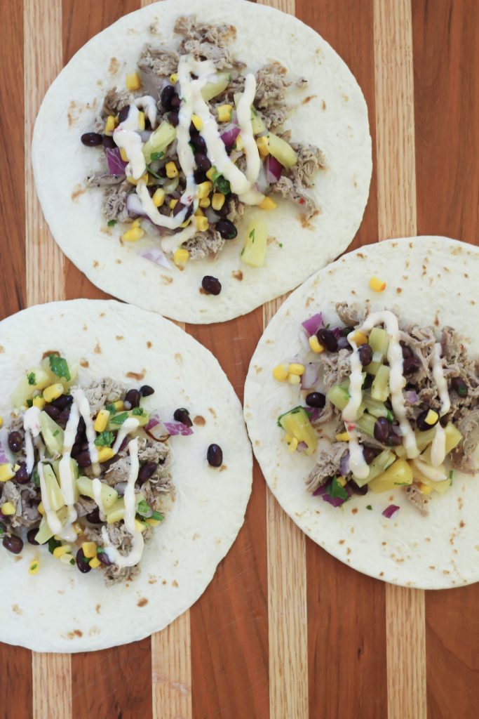 These shredded pork tacos are topped with a homemade pineapple salsa and drizzled with a store-bought queso dip. They're insanely flavorful & perfect for a weeknight or weekend dinner. Ready in 30 minutes, you'll be adding this to your frequently dinner rotation. Click for the full recipe!