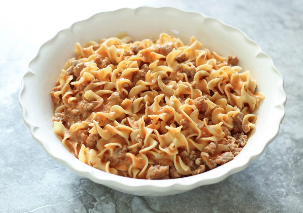 Noodles with Sausage and Creamy Marinara - This easy dinner recipe is a crowd pleaser for kids and adults alike. It's quick, cheap, and absolutely delicious! The creamy sauce pairs well with the sausage and fluffy noodles. Yum! 
