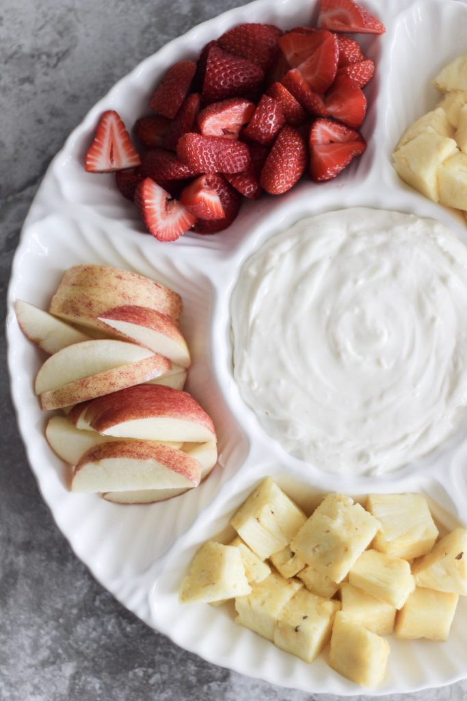 This easy peasy two-ingredient fruit dip recipe takes just a couple minutes to whip together and is sure to be a hit at your next shower, barbecue, or even as a sweet treat you keep in the refrigerator all to yourself. It combines marshmallow fluff or marshmallow creme and a bar of cream cheese. It's versatile and could be enhanced with chocolate, caramel, or other flavorings like strawberry, lemon, or blueberry. Even add food coloring! Apples, strawberries, pineapple, and other fruits are all perfect dippers for this delicious dip. Full recipe on Whimsical September blog. 